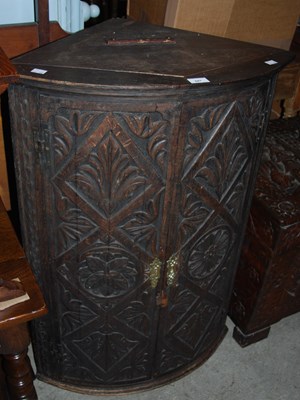 Lot 847 - A Jacobean style carved oak hanging corner...