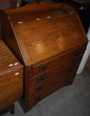 Lot 865 - An oak drop-leaf table together with an oak...