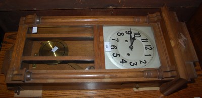 Lot 866 - An oak framed wall clock with Arabic numeral...