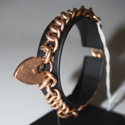 Lot 78 - A yellow metal bracelet with heart-shaped lock...
