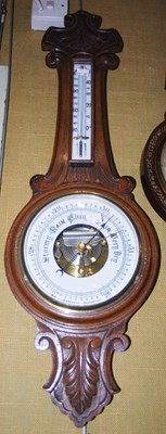 Lot 701 - A late 19th century oak aneroid barometer with...