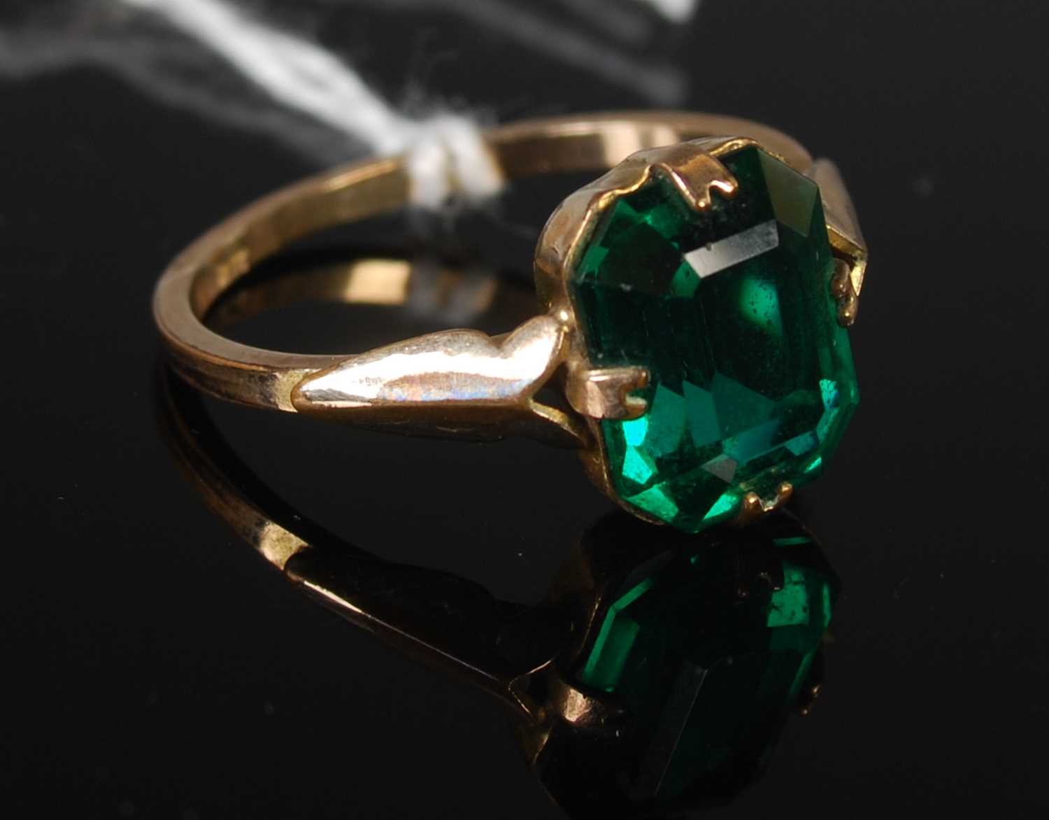 Lot 40 - A yellow metal and synthetic dress ring...