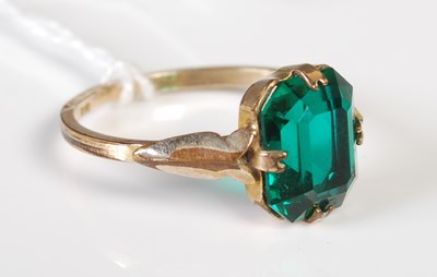 Lot 40 - A yellow metal and synthetic dress ring...