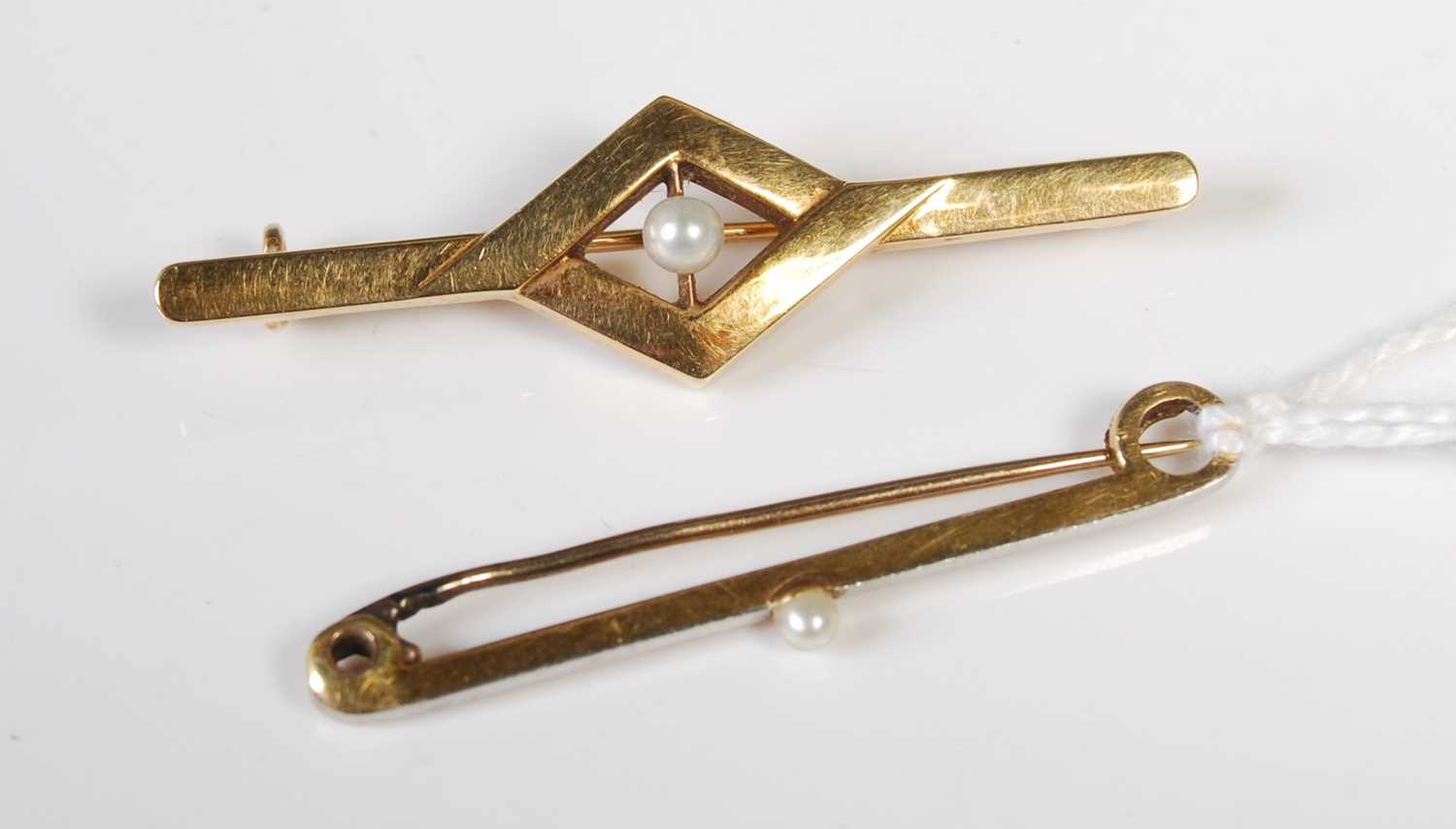 Lot 60 - A vintage white and yellow metal bar brooch...