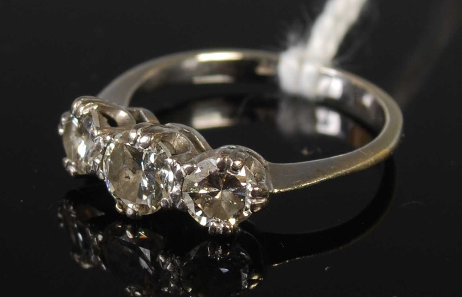 Lot 69 - A white metal and diamond three stone ring,...