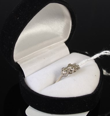 Lot 69 - A white metal and diamond three stone ring,...