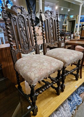 Lot 801 - A pair of antique oak carved hall chairs with...