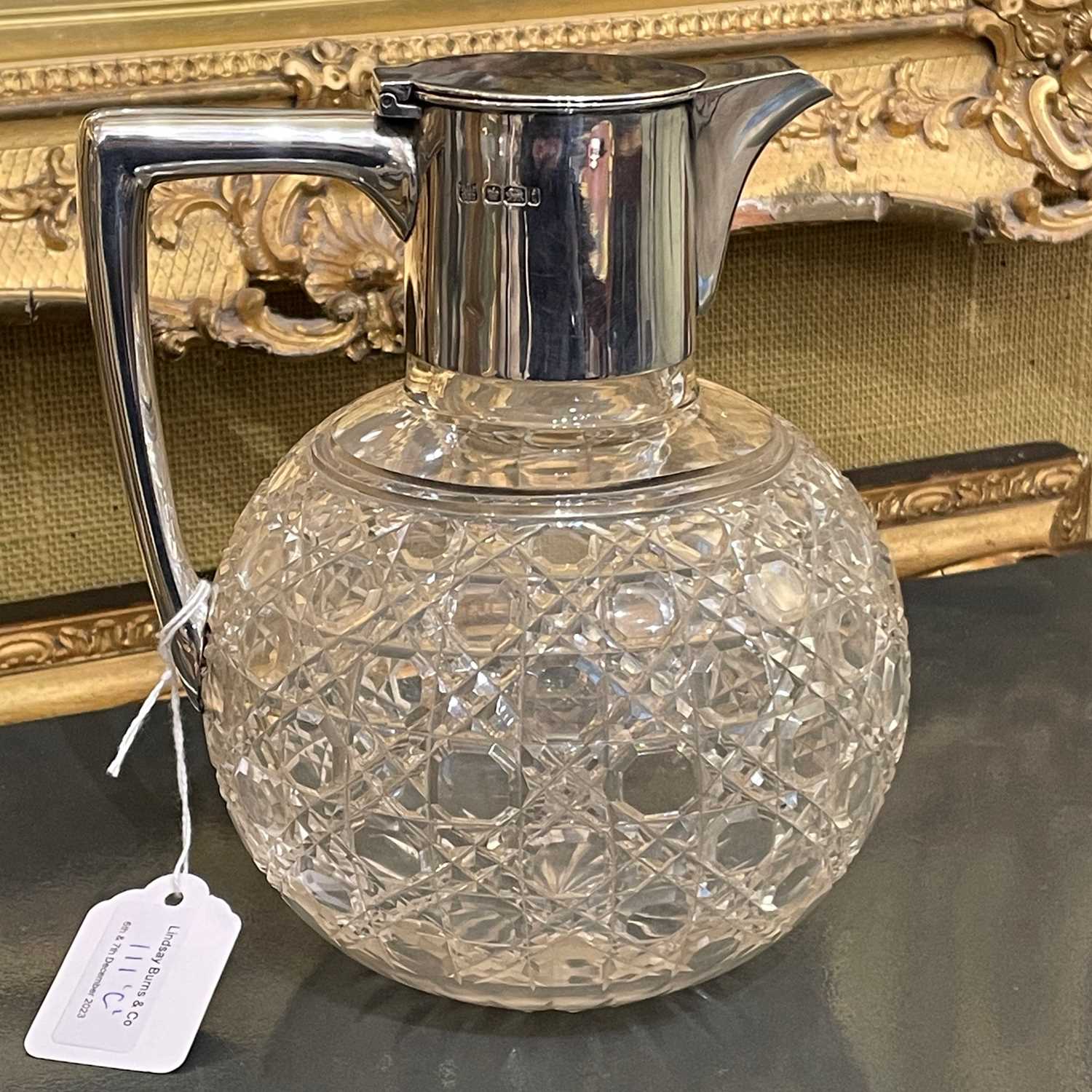 Lot 111 - An Edwardian silver mounted cut glass claret...