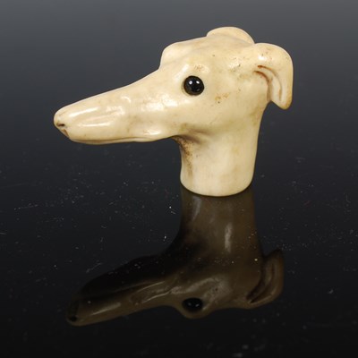 Lot 95 - Dog interest: an antique carved bone walking...