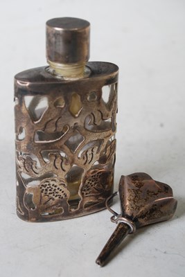 Lot 130 - A clear glass and white metal overlaid scent...