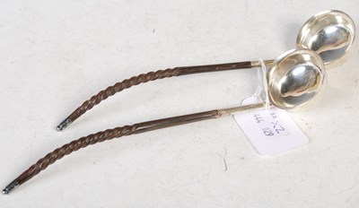 Lot 143 - A pair of electroplated toddy ladles with...