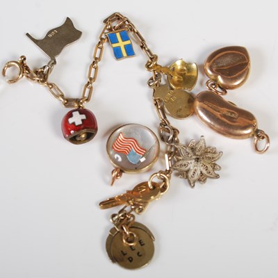 Lot 56 - A yellow metal charm bracelet stamped '9C'...