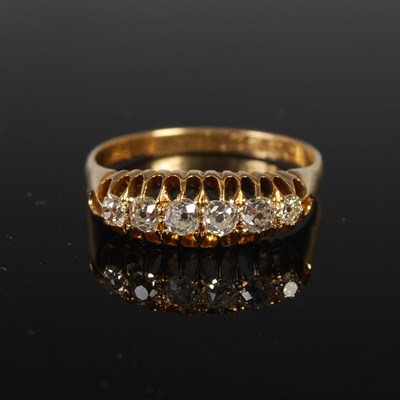 Lot 60 - An 18ct gold and diamond six stone ring, size...