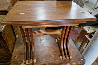 Lot 807 - A mid-century teak nest of three tables by G...