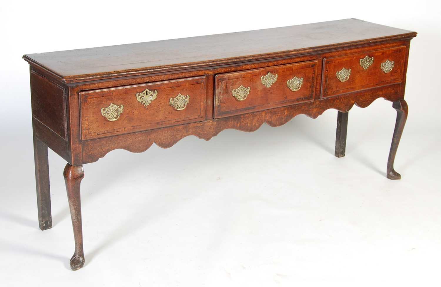 Lot 45 - A George III oak dresser, the rectangular top...