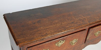 Lot 45 - A George III oak dresser, the rectangular top...