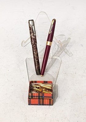 Lot 58 - Two vintage fountain pens, one in red with...