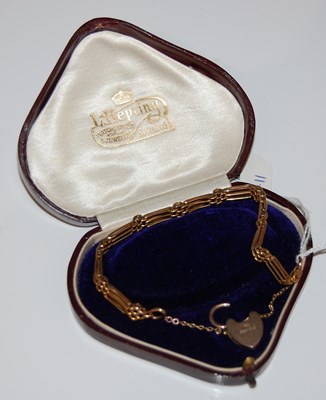Lot 24 - A vintage yellow metal gate-link bracelet...