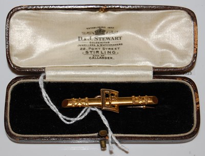 Lot 37 - A yellow metal bar brooch centred with a...