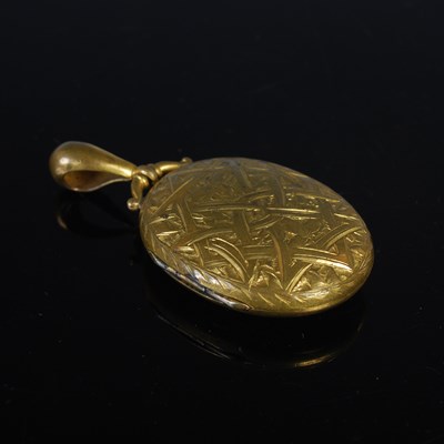 Lot 77 - A Victorian yellow metal oval mourning locket,...