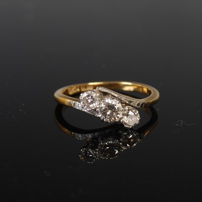 Lot 53 - A white and yellow metal three-stone diamond...