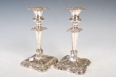 Lot 123 - A pair of Sheffield plate candlesticks, each...